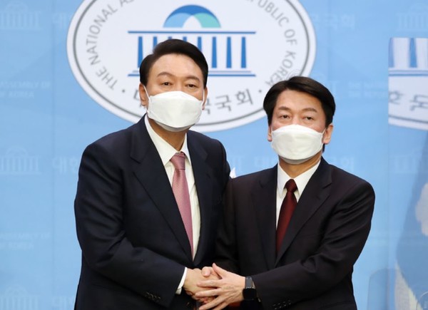 야권 단일화에 전격 합의한 국민의힘 윤석열 대선 후보와 국민의당 안철수 대선 후보가 3일 오전 서울 여의도 국회 소통관에서 공동 기자회견을 마친 뒤 함게 손을 잡고 있다.(뉴시스 제공)