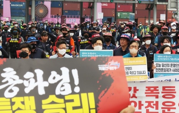 민주노총 공공운수노조 화물연대본부가 안전 운임 일몰제 폐지 등을 요구하며 총파업에 돌입한지 일주일째인 지난달 13일 오후 인천 연수구 인천신항 컨테이너 터미널 앞에서 인천지부 조합원들이 구호를 외치고 있다. (뉴시스 제공) 