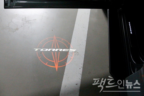 스마트키를 통해 운전석 문을 열자, 바닥에 토레스라는 차명이 선명하다. 웰컴 기능으로 쌍용차의 고급 SUV 렉스턴 스포츠 브랜드부터 실렸다. [사진=정수남 기자]