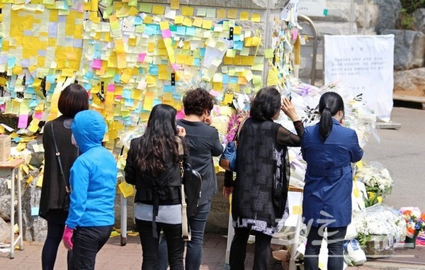 단원고 정문에도 학생들을 추모하는 포스트잇이 가득하고, 일부 직장인과 주민이 점심시간을 이용해 단원고를 찾아 희생자를 기렸다. 이곳을 찾은 이들도 오열했다. [사진=정수남 기자]