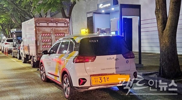 기아자동차 니로 전기차 택시가 충전하고 있다. 택시 기사는 운전석에 앉아 스마트 전화기를 보면서 휴식하고 있다. 100㎾ 급속충전기로 니로 배터리를 80%까지 충전하는 데 45분이 걸리기 때문이다. [사진=정수남 기자]